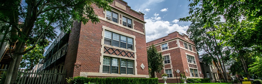 A red brick building with a white window in the middle of it.