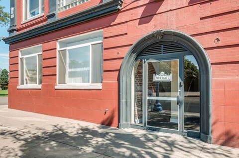 A red building with a sign that says Detroit on it.