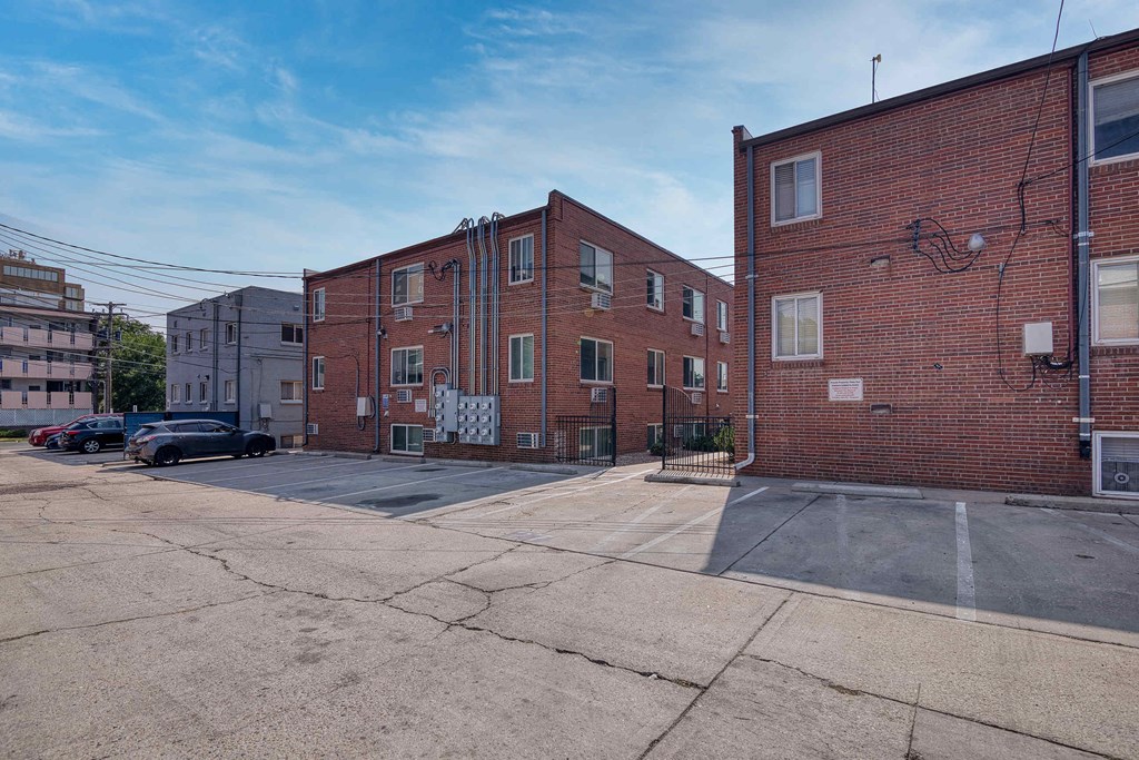 a red brick building on a city street with cars