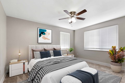 a bedroom with a bed and a ceiling fan