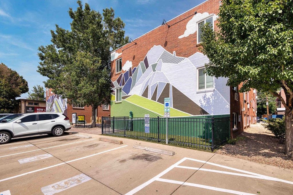 a mural on the side of a building in a parking lot