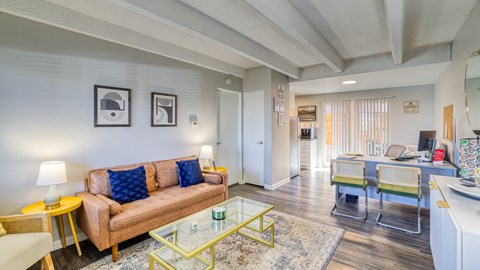 a living room with a couch and a glass table