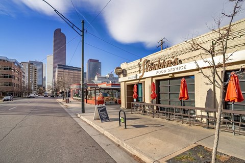 A street view of a city with a building named Christi's Food Service.