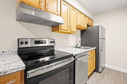 a kitchen with stainless steel appliances and wooden cabinets