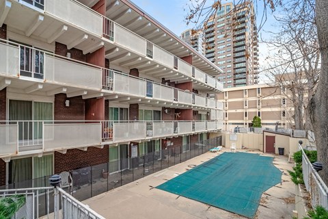 Apartment complex with a pool in the courtyard.
