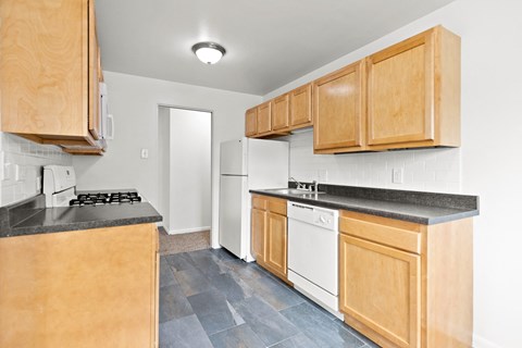 a kitchen with wooden cabinets and white appliances