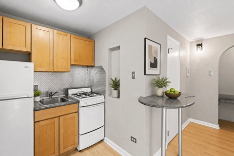 A kitchen with a white refrigerator and a white stove.