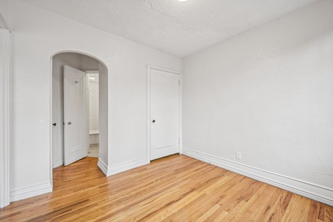 A room with a wooden floor and white walls.