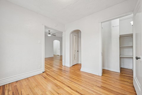 A room with wooden floors and white walls.