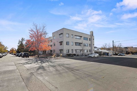 an apartment building on the corner of a city street