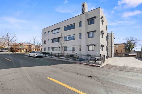 a large white building with a street in front of it