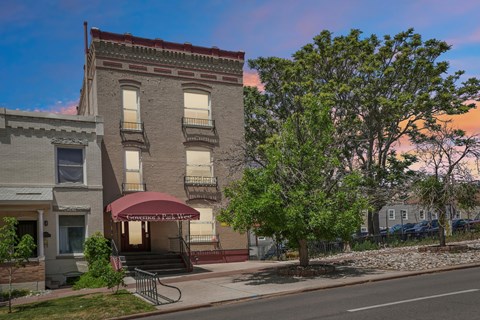 A building with a red awning is in the foreground of the image.