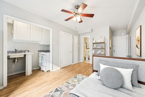 a living room with a couch and a ceiling fan