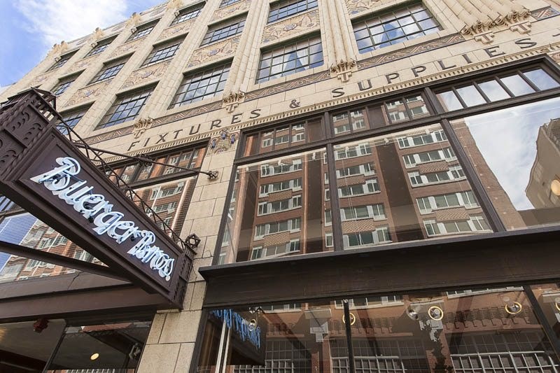 A building with a sign that says "Fixtures & Supplies" on it.