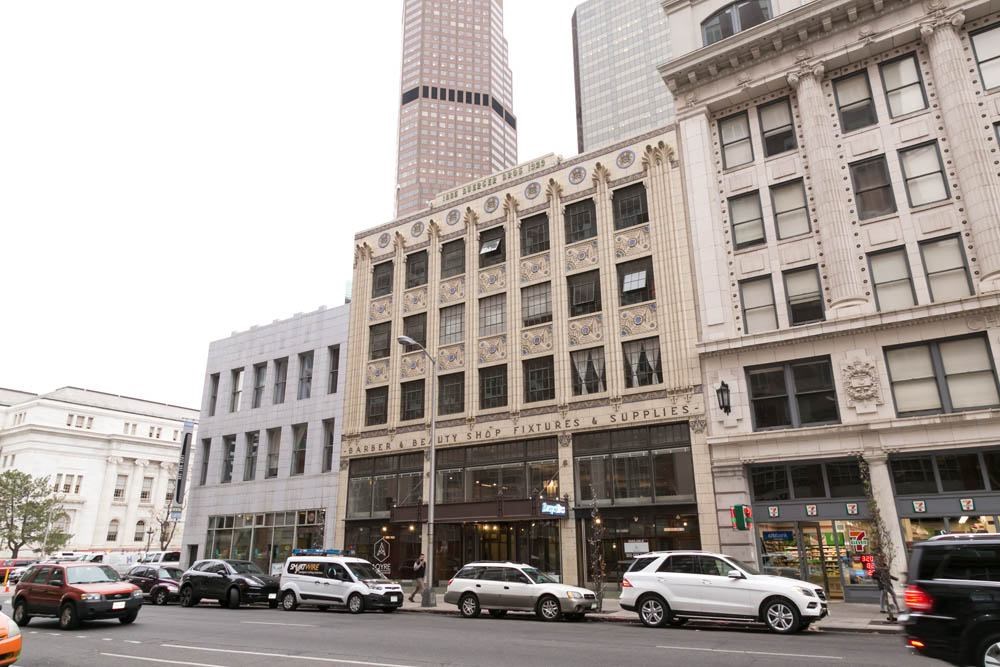 A street view of a city with cars and buildings.