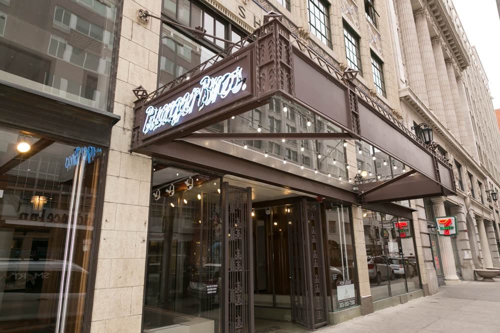 Brown building with a sign that says "Bowery".