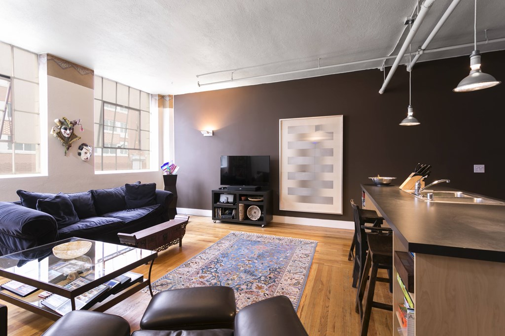 A living room with a blue couch and a television.