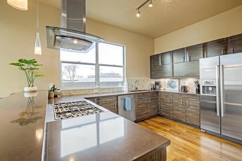 a kitchen with stainless steel appliances and a large window