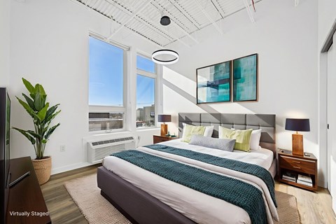 A bedroom with a large bed and a flat screen TV.
