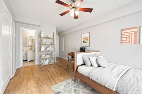 a bedroom with a bed and a ceiling fan