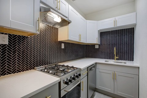 A kitchen with a stove top oven and a microwave.
