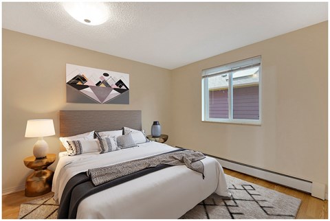 a bedroom with a large bed and a window