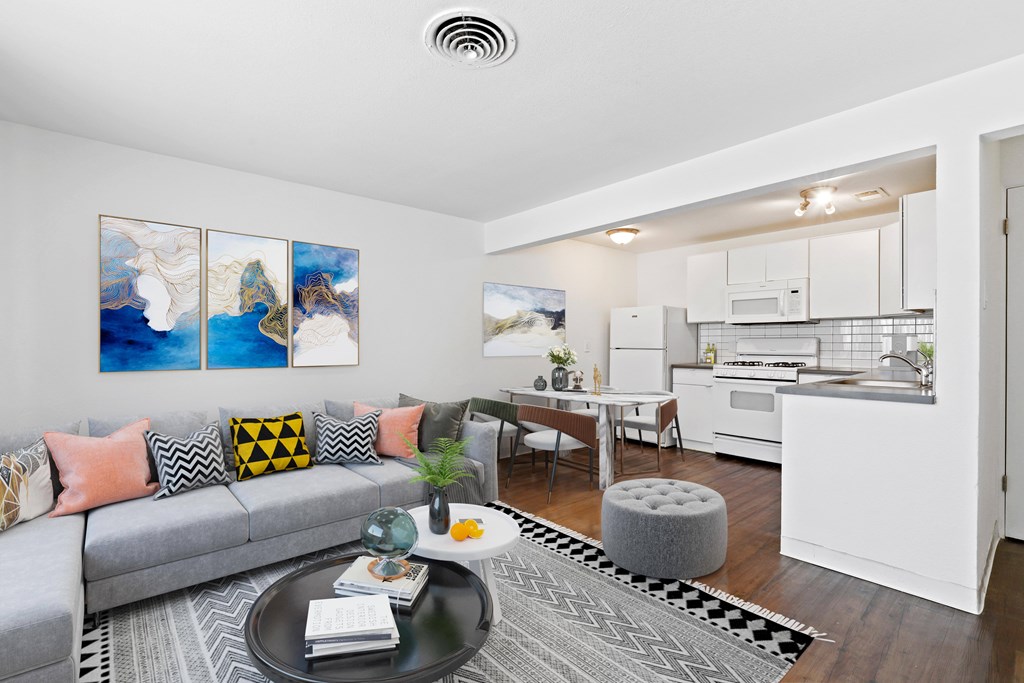 A modern living room with a grey couch and a coffee table.