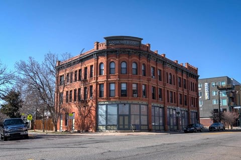 an old brick building on the corner of a city street