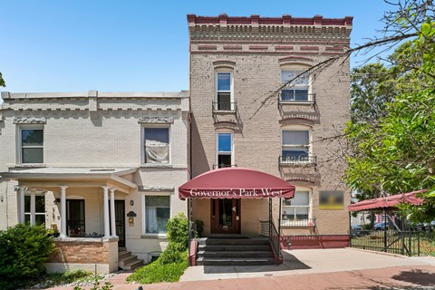 A building with a red awning that says "Governor's Park West".
