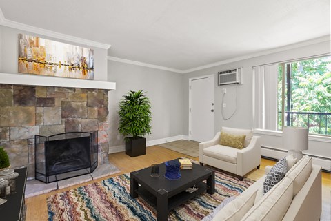 a living room with a stone fireplace and a couch and a coffee table