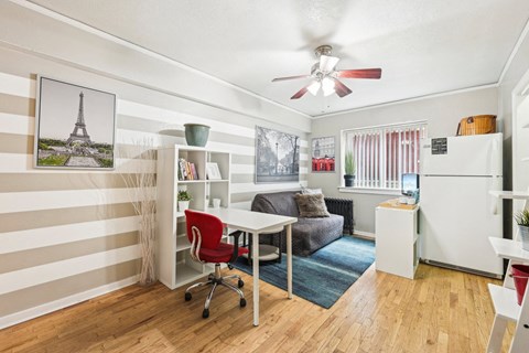 a living room with a desk and a couch