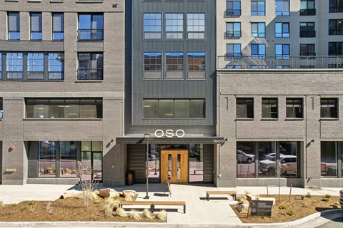 The image shows a modern building with the word "OSO" prominently displayed above the entrance.