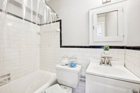 a white bathroom with a white toilet and a sink