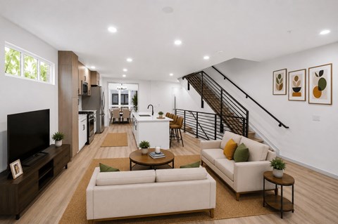A living room with a staircase and a television.