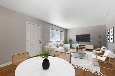 a living room with a white table and chairs and a couch