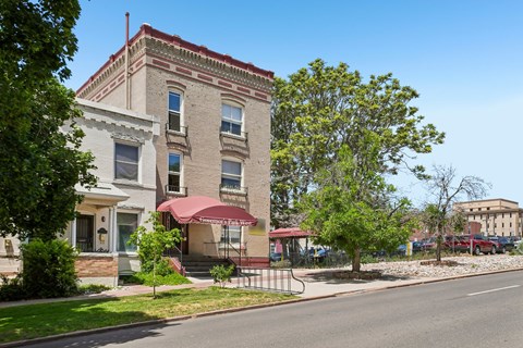 A building with a red awning is in the foreground of the image.
