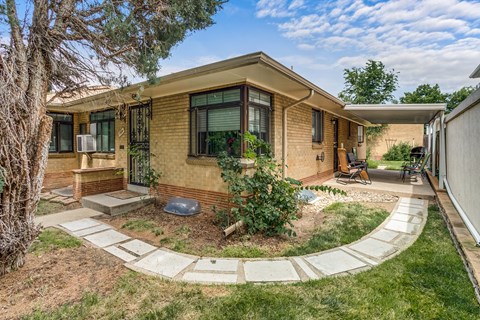 A house with a brown brick exterior and a white roof.