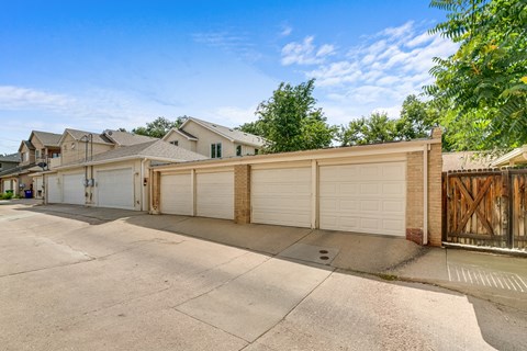A row of garages with a clear blue sky above.
