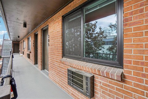 A long brick building with a window and a door.