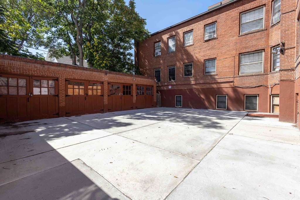 a large parking lot with a red brick building