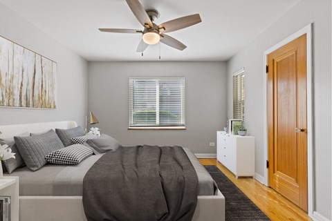 a bedroom with a large bed and a ceiling fan