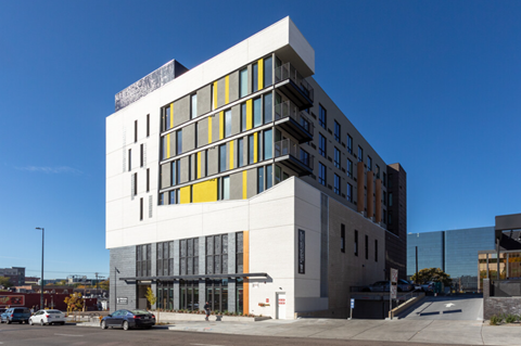 a white and yellow building on a city street