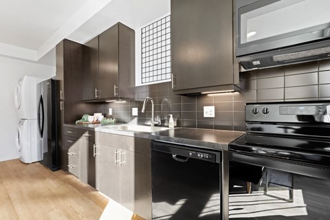 a modern kitchen with stainless steel appliances and a sink