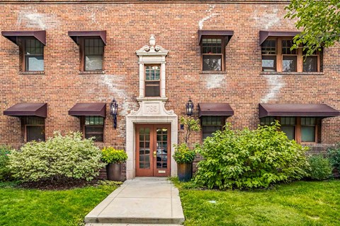 A red brick building with a white door and windows.