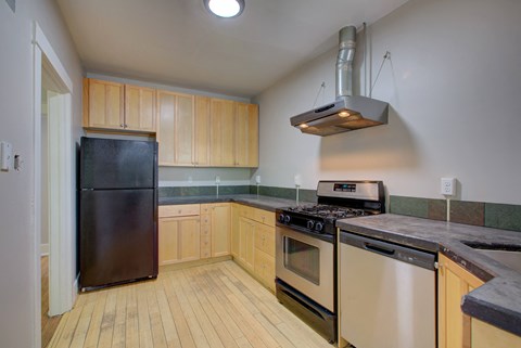 a kitchen with stainless steel appliances and wooden cabinets