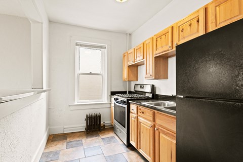 a kitchen with black appliances and wooden cabinets