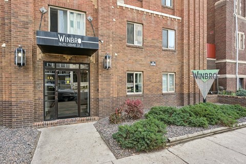 a brick building with a sidewalk in front of it