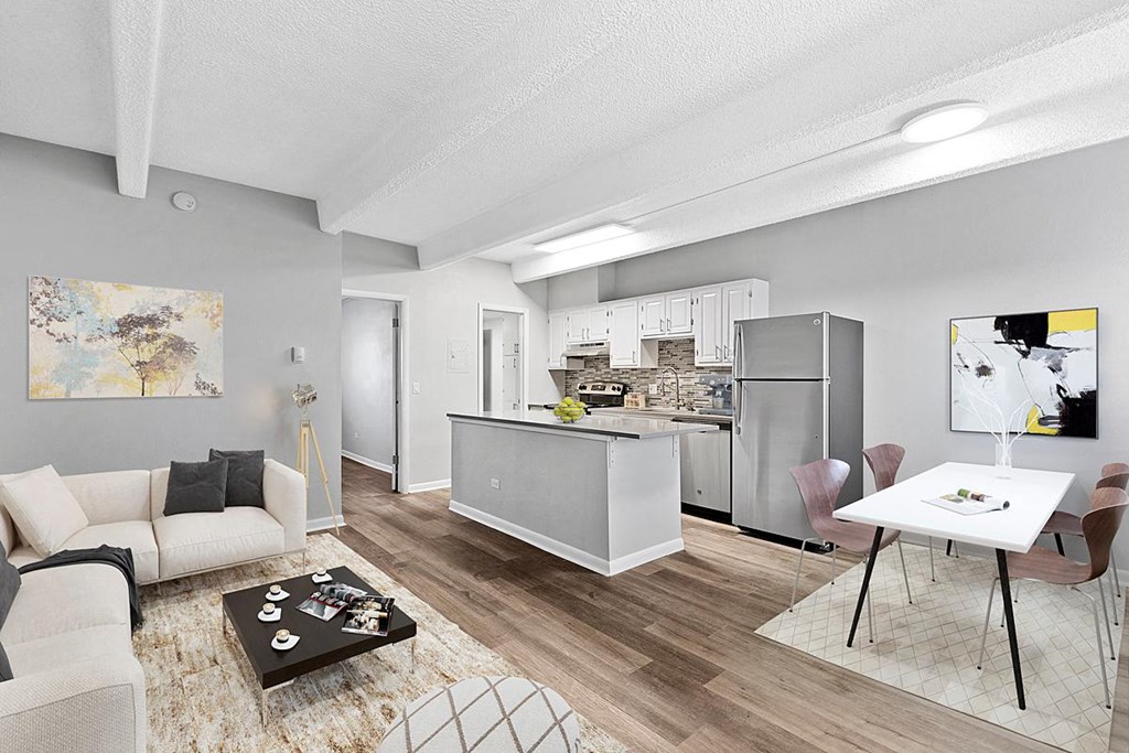 A modern kitchen with a dining table and chairs.
