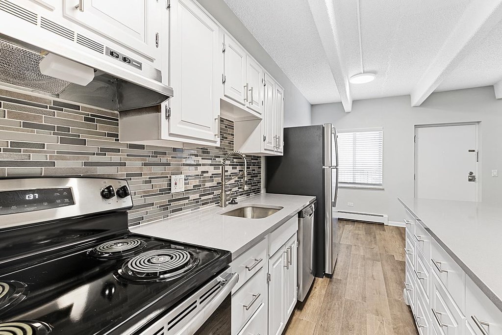 A modern kitchen with a black stove top oven.