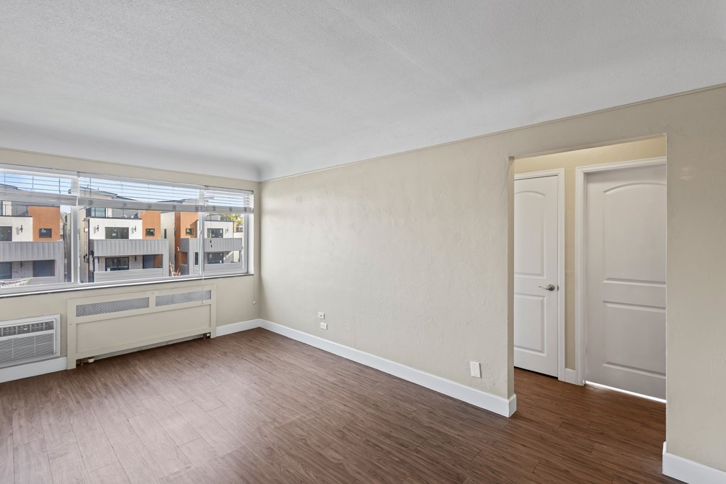 A room with a wooden floor and white walls.
